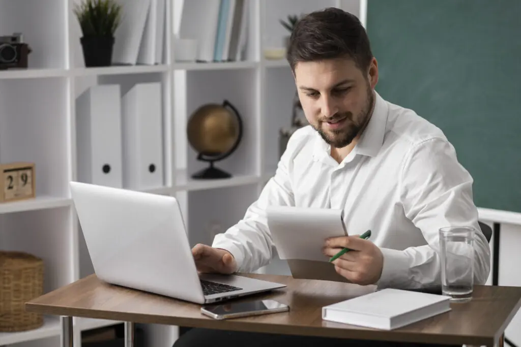medium-shot-man-making-list-with-laptop
